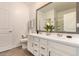 Bathroom featuring large mirror, dual sinks, spacious vanity with modern cabinets, and wood-style floors at 12351 W Palmaire Ave, Glendale, AZ 85307