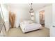 Bright bedroom featuring a large window, neutral tones, and ensuite bathroom at 12351 W Palmaire Ave, Glendale, AZ 85307