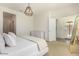 Bedroom with neutral tones, large window, and ensuite bathroom access at 12351 W Palmaire Ave, Glendale, AZ 85307