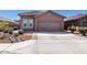 Inviting front yard featuring a two-car garage, desert landscaping and well-maintained walkway at 12351 W Palmaire Ave, Glendale, AZ 85307