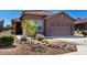 Charming home featuring a well-kept front yard with desert landscaping and a two-car garage at 12351 W Palmaire Ave, Glendale, AZ 85307