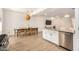 Open concept kitchen with stainless steel appliances and adjacent dining area at 12351 W Palmaire Ave, Glendale, AZ 85307