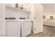 Well-lit laundry room featuring modern washer and dryer with convenient access to other rooms at 12351 W Palmaire Ave, Glendale, AZ 85307