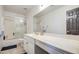This bathroom offers a shower-tub combination with a glass door and a vanity at 12905 W Crocus Dr, El Mirage, AZ 85335