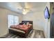 This bedroom features wood-look floors, a ceiling fan, and a window at 12905 W Crocus Dr, El Mirage, AZ 85335