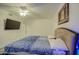 This bedroom features carpet floors, a ceiling fan, and a window at 12905 W Crocus Dr, El Mirage, AZ 85335