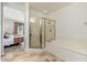 Bright bathroom showcasing a glass shower and soaking tub, adjacent to the bedroom at 13300 E Via Linda -- # 1054, Scottsdale, AZ 85259