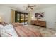 Bedroom featuring two beds, patio access, and a large TV at 13300 E Via Linda -- # 1054, Scottsdale, AZ 85259