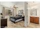 Well-lit bedroom with a metal bed frame and bathroom access at 13300 E Via Linda -- # 1054, Scottsdale, AZ 85259