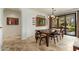 Dining room with a wooden table and chairs, stylish mirror, and sliding doors to the outside at 13300 E Via Linda -- # 1054, Scottsdale, AZ 85259