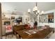 Open-concept dining area connected to the living room, featuring a wooden table and views throughout the house at 13300 E Via Linda -- # 1054, Scottsdale, AZ 85259