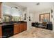 Open kitchen with dark countertops, light wood cabinets, and a conveniently placed office area at 13300 E Via Linda -- # 1054, Scottsdale, AZ 85259