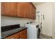 Laundry room features wood cabinetry, counter space, and a modern washer and dryer set at 13300 E Via Linda -- # 1054, Scottsdale, AZ 85259