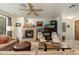 Cozy living room featuring a stone fireplace, comfortable seating, and neutral tones at 13300 E Via Linda -- # 1054, Scottsdale, AZ 85259