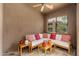 Covered patio with neutral tones, wooden furniture, and colorful pillows with geometric designs at 13300 E Via Linda -- # 1054, Scottsdale, AZ 85259
