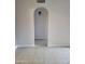 Hallway featuring an arched entryway and neutral walls with bright light at 1449 E Highland Ave # 39, Phoenix, AZ 85014