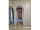 Hallway featuring an arched entryway, neutral walls and tile flooring at 1449 E Highland Ave # 39, Phoenix, AZ 85014