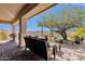 Charming covered patio with comfortable seating overlooking the meticulously landscaped backyard at 16113 E Andrew Dr, Fountain Hills, AZ 85268