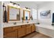 Stylish bathroom with dual sinks, framed mirrors, a soaking tub, and modern fixtures at 16113 E Andrew Dr, Fountain Hills, AZ 85268