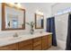 Bright bathroom featuring double sinks with framed mirrors and a combined shower and tub at 16113 E Andrew Dr, Fountain Hills, AZ 85268