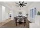Cozy dining room area with designer ceiling fan, neutral walls and carpet, plus views to other living spaces at 16113 E Andrew Dr, Fountain Hills, AZ 85268