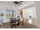 Bright dining room featuring plantation shutters, designer ceiling fan, neutral walls and carpet, plus views to the entry at 16113 E Andrew Dr, Fountain Hills, AZ 85268
