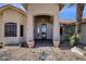Inviting front door featuring a covered entrance, desert landscaping, and an arched entryway at 16113 E Andrew Dr, Fountain Hills, AZ 85268