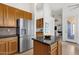 Stylish kitchen with stainless steel refrigerator, granite countertops, breakfast bar, wood cabinets and tile floors at 16113 E Andrew Dr, Fountain Hills, AZ 85268