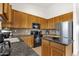 Kitchen with granite countertops, stainless steel appliances, tile backsplash and wood cabinets at 16113 E Andrew Dr, Fountain Hills, AZ 85268
