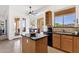 Well-lit kitchen featuring granite countertops, breakfast bar, wood cabinets and tile floors at 16113 E Andrew Dr, Fountain Hills, AZ 85268