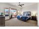 Inviting bedroom featuring a ceiling fan, a backyard view, and sliding door access to a private patio at 16113 E Andrew Dr, Fountain Hills, AZ 85268