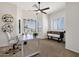 Bright home office featuring plantation shutters, designer ceiling fan, neutral walls and carpet and modern furniture at 16113 E Andrew Dr, Fountain Hills, AZ 85268