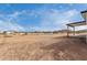 Expansive backyard, covered patio, and desert landscape, creating a blank canvas for outdoor living at 16567 N Slate Ln, Maricopa, AZ 85139