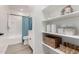 Bright bathroom boasts a tub, white vanity, and decorative shelving for stylish storage at 16567 N Slate Ln, Maricopa, AZ 85139