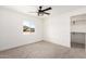 Bedroom featuring a window with a view, a walk-in closet and a ceiling fan at 16567 N Slate Ln, Maricopa, AZ 85139
