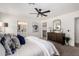 Bright bedroom boasts stylish decor, a walk-in closet and a ceiling fan at 16567 N Slate Ln, Maricopa, AZ 85139