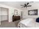 Bright bedroom offers ample space, closet and a ceiling fan at 16567 N Slate Ln, Maricopa, AZ 85139