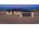 Beautiful single-story home showcasing modern exterior lighting, gray garage door, and minimalist desert landscaping at 16567 N Slate Ln, Maricopa, AZ 85139
