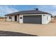 Single story home with a large garage, a new dark roof, and desert landscaping at 16567 N Slate Ln, Maricopa, AZ 85139