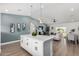 Open concept kitchen showcases modern island and access to the living room and outdoor spaces at 16567 N Slate Ln, Maricopa, AZ 85139