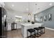 Kitchen showcases a large island, stainless appliances and window over the sink at 16567 N Slate Ln, Maricopa, AZ 85139