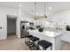 Modern kitchen with stainless steel appliances, marble countertops and island with bar stool seating at 16567 N Slate Ln, Maricopa, AZ 85139
