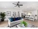 Bright, open-concept living room with stylish furnishings and abundant natural light flows into the kitchen at 16567 N Slate Ln, Maricopa, AZ 85139