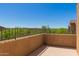 Private balcony overlooking lush greenery and distant rooftops perfect for relaxation at 16600 N Thompson Peak Pkwy # 1072, Scottsdale, AZ 85260