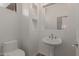 This powder room offers a modern pedestal sink and streamlined design at 16600 N Thompson Peak Pkwy # 1072, Scottsdale, AZ 85260