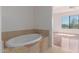 Bright bathroom features a soaking tub with tile surround and views to the main bedroom at 16600 N Thompson Peak Pkwy # 1072, Scottsdale, AZ 85260