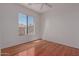 Bright bedroom with hardwood floors and a large window showing the neighborhood at 16600 N Thompson Peak Pkwy # 1072, Scottsdale, AZ 85260