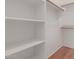 Spacious walk-in closet featuring built-in shelving and wood floors for optimal storage solutions at 16600 N Thompson Peak Pkwy # 1072, Scottsdale, AZ 85260