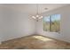 Bright dining room with slate floors, chandelier, and views of the natural desert landscape at 16600 N Thompson Peak Pkwy # 1072, Scottsdale, AZ 85260
