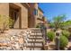 Inviting home exterior showcasing rock landscaping, desert foliage, and a pathway leading to the front door at 16600 N Thompson Peak Pkwy # 1072, Scottsdale, AZ 85260